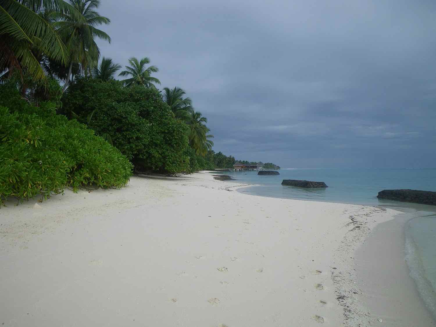 The beach at Kuramathi Maldives looking toward its overwater villas, North Ari Atoll