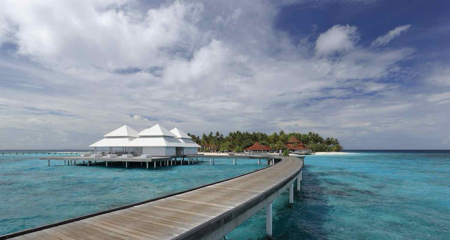 Overwater villas and the arrival jetty at Diamonds Thudufushi, South Ari Atoll